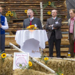 Fünf Personen auf der Bühne und zwei sprechen ins Mikrofon ans Publikum