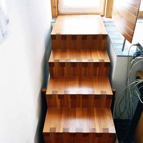 Holztreppe mit präzisen Fingerzinkenverbindungen.